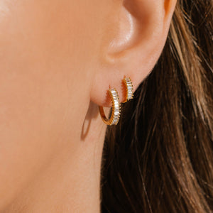 The Baguette Hoop Duo shown worn together, stacked on a single ear to display contrast in size – perfect for layered elegance.