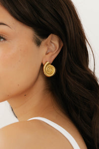 Side profile of model showcasing the elegant gold By The Sea Earring, styled with loose hair and a white tank top. By The Perfect Hoop.
