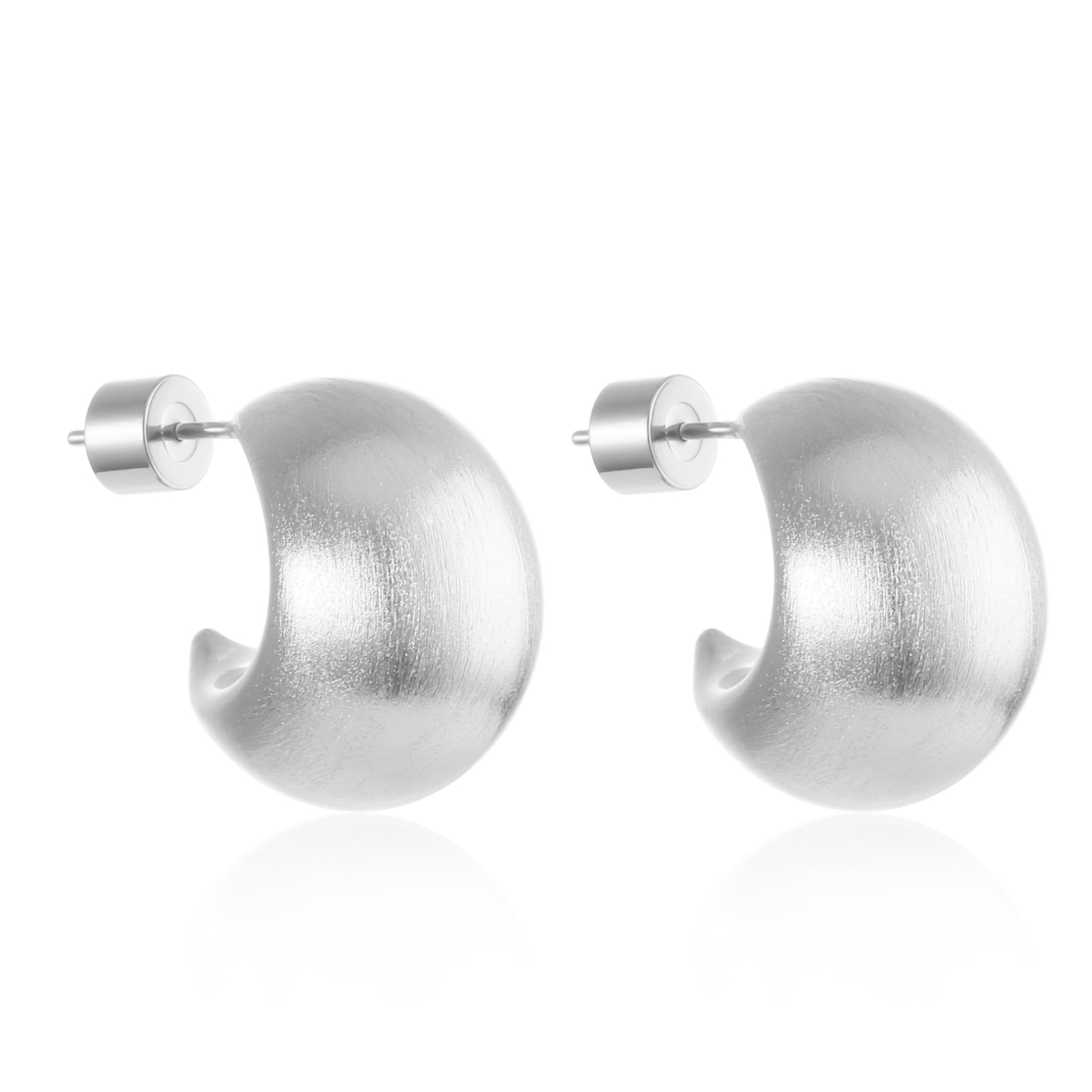 A pair of sterling silver Cordoba Hoop Matte earrings are displayed againt a white background to show off the subtle matte texture, crescent shape, and cylindrical push-back closure. 