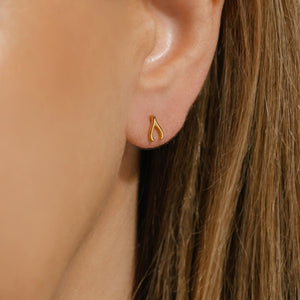 Close-up of The Make-a-Wish Stud worn on the ear, showcasing its delicate golden wishbone design, perfect for adding subtle elegance to everyday wear.