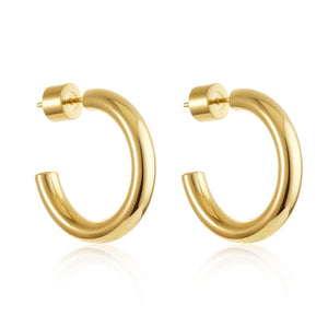 The Malta Hoop 27 mm in gold shown in a clean white background with reflective finish and soft shadows. By The Perfect Hoop.