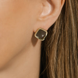 Model wearing The Mochachino Hoop earrings, featuring a rich mocha-brown enamel finish in a soft square design framed in gold, offering a modern and refined look.