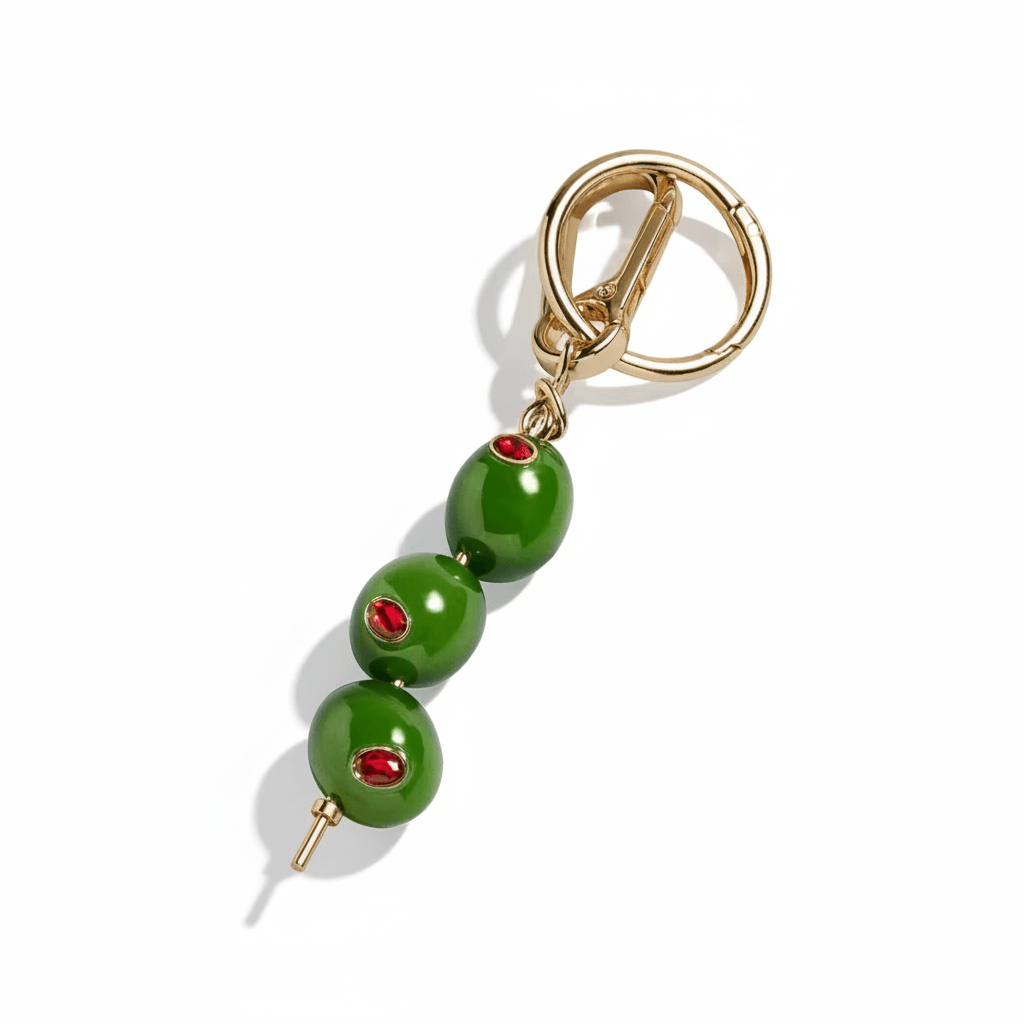 The Perfect Hoop The Extra Dirty Keychain featuring green olive bead charms with red crystal accents and gold clasp, shown on a white background