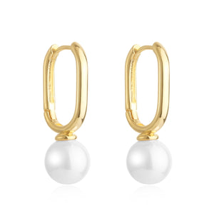 Gold hoop earrings with an elongated oval shape featuring a dangling glossy white pearl accent, displayed on a white background for a sleek and elegant look.