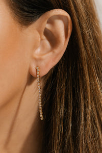The sparkling crystal accents cascade gracefully from the model's ear. 