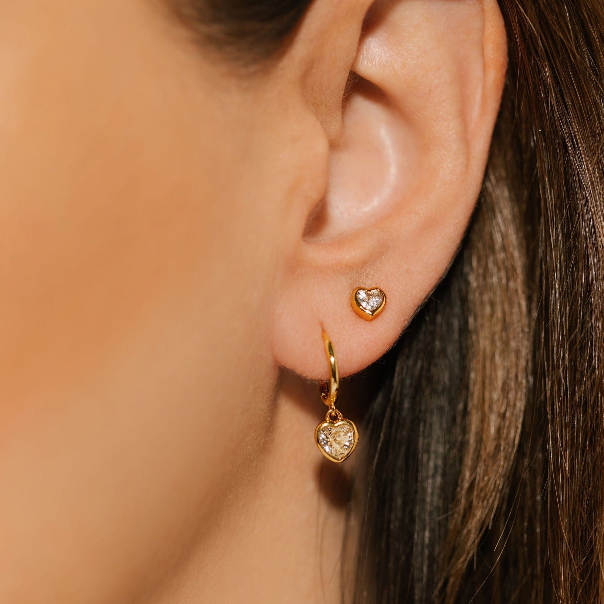 The Amore Solitaire Duo is worn as an earring stack, the Solitaire Stud adding a delicate accent as the Amore Drop Hoop gracefully dangles from her ear.  