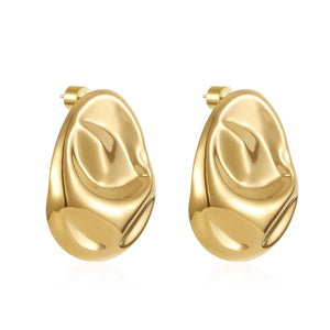 The Portofino Earring – gold sculptural drop earrings with an organic, fluid silhouette, photographed against a white background.