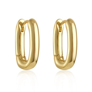 The Positano Hoop Mini in polished gold, photographed on a pure white background, featuring a bold oval shape and hinge closure mechanism.  By The Perfect Hoop.