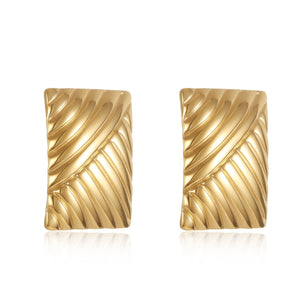 The Selene Earring – gold rectangular ridged stud earrings with sculptural detailing on white background