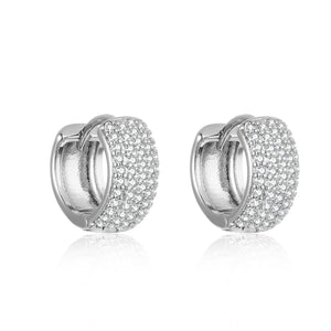 Two white gold Sicily Hoop Pavé earrings are shown against a white background to highlight the rows of sparkling accents and broad hoops. 