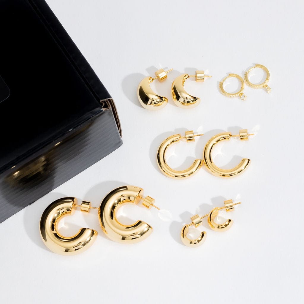 The five pairs of sleek hoop earrings in the Clean Girl Aesthetic Hoop Starter Pack show off their golden curves as they lay side by side on a white surface.
