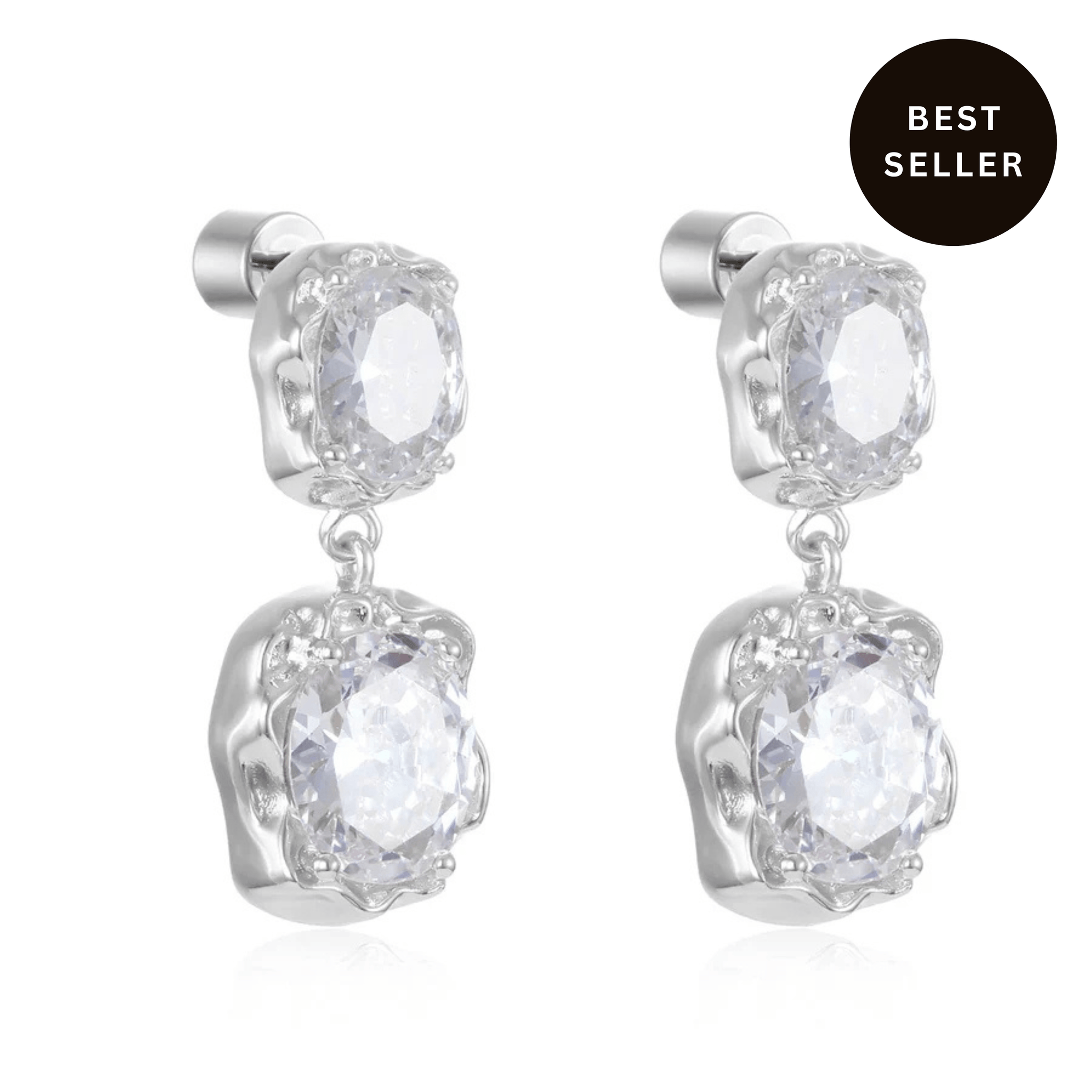 The Aura Casila Drop Earrings in sterling silver with twin crystal accents, best seller badge, white product background.