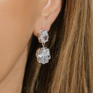 The two crystals in the sterling silver Aura Hoop sparkle brightly on the model's ear. 