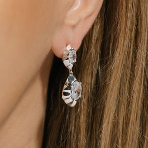 The organically shaped, sterling silver Aura Casila Hoop with offset crystal accents sparkles on the model's ear. 