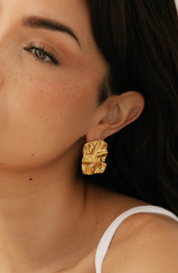 Detailed view of The Soleil Hoop by The Perfect Hoop, crafted in a rich gold finish with bold, artistic folds.