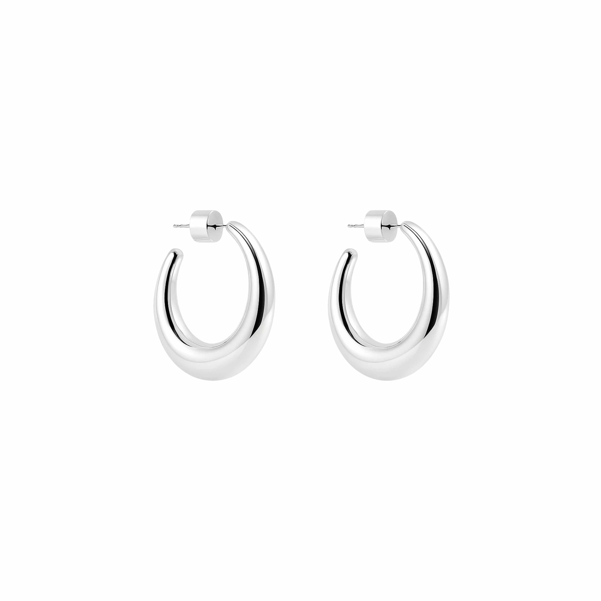 Pair of silver crescent hoop earrings on a white background by The Perfect Hoop.