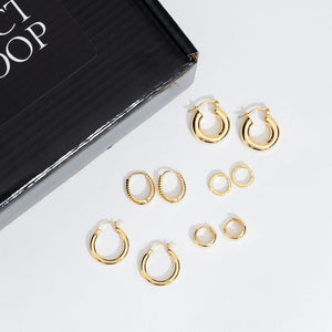 The five pairs of simple and delicate hoop earrings in the Minimalistic Hoop Starter Pack are displayed together on a white surface to show off their variety of designs. 