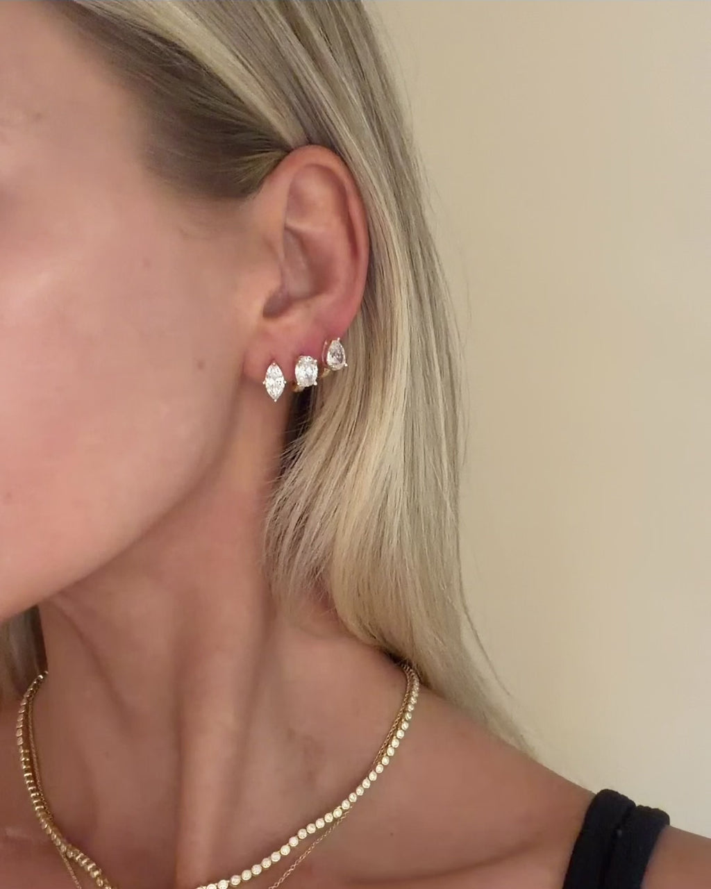 Video showcasing the Kennedy Huggie Trio, three pairs of front-facing crystal gold huggie earrings in Marquise, Pear and Oval cuts.