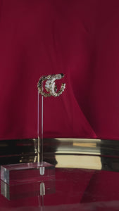 A 360-degree video shows the serpentine, open hoop design of the Diana Hoop earring. 