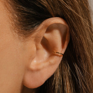 The model's hair is pulled behind her ear to show off the Perfect Cuff gently wrapped around the middle portion of her ear.